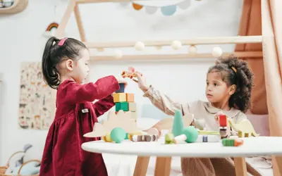 Two girls playing with blocks